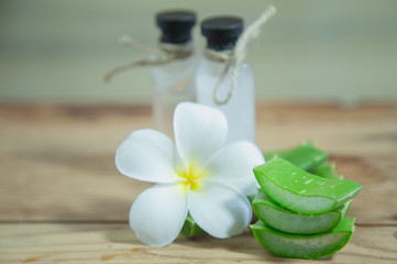 Aloe vera Fresh stacked with drop water and aloe vera juice in glass bowl with honey in jar on old wood