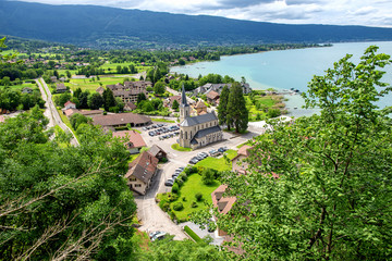 view of Annecy lake in french Alps with Duingt village - obrazy, fototapety, plakaty