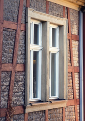 Big window on an old historical sandstone facade building
