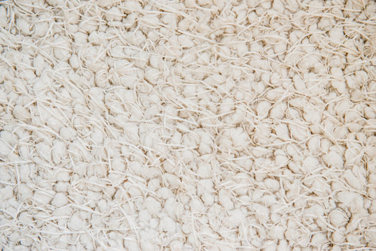 Knitted fabric close-up of beige color. abstract. background