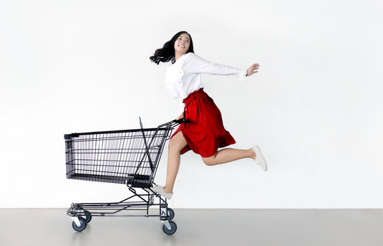 Happy Asian Woman With Shopping Cart Ready For Shopping On Sale