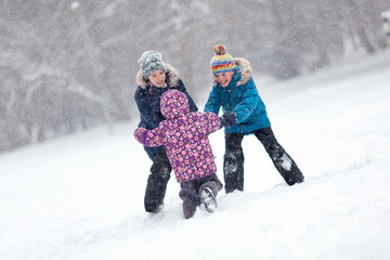 Walk fun children in winter park. Happy Brother and sister playing outside.