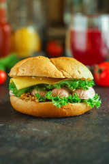 burger with sausages, cheese, lettuce, tomato sauce (snack sandwich, kaiser bun). top food background. copy space