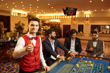 A croupier works at a poker roulette in a casino.
