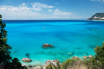 Naklejka na ściany i meble Beautiful tropical lagoon seascape with white boat in blue water. Greece, Lefkada island.