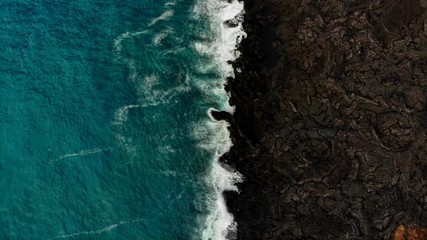 cinemagraph of the ocean against contrasting lava flow near Isaac hale park and kapoho that was recently destroyed by lava in 2018