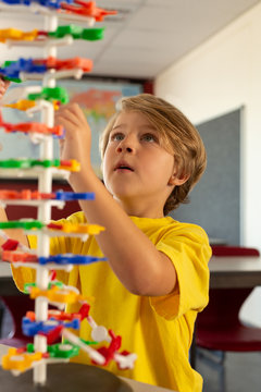 Boy learning science model in classroom