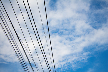 electric pole and electric wire on blue sky background.
