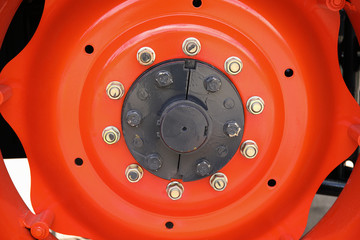 Closeup of an agricultural machinery tire with on an orange wheel