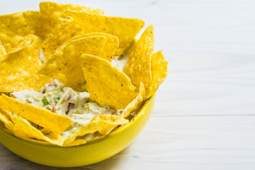 Tortilla chip made from corn tasty Tex-Mex food or snack on a wooden table.
