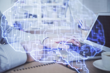 Man typing on keyboard background with brain hologram. Concept of big Data. Double exposure.