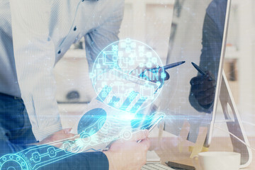 Crypto currency theme hologram with businessman working on computer on background. Concept of...