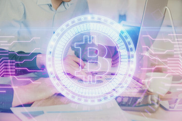 Fototapeta premium Crypto currency theme hologram with businessman working on computer on background. Concept of blockchain. Multi exposure.
