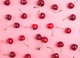 Naklejka na ściany i meble Delicious ripe red cherries on the pink background.