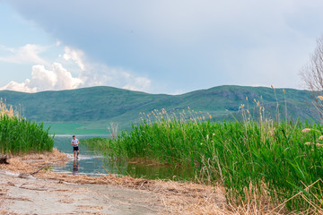 sea landscape with mountines and canes, blue sky with clouds, cloudly without sun, kazakhstan