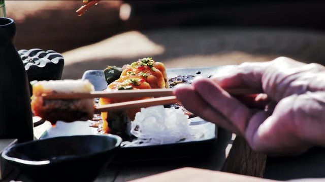 Eating sushi with chopsticks in 
Asia