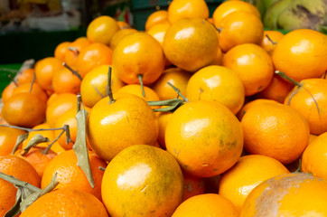 orange fruit stacked on the marketplace
