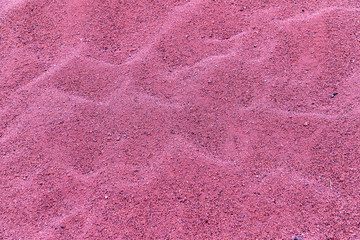 Closeup view at a pile of a red sand.