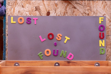 Wooden box for lost items with "Lost and Found" title above it. The title made from glittering foam letters