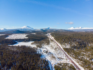 Aerial view at Cascade Lakes national Scenic Byway with Mt Bachelor and Three Sister mountains from above the Wanoga snow park, Bend, Central Oregon,