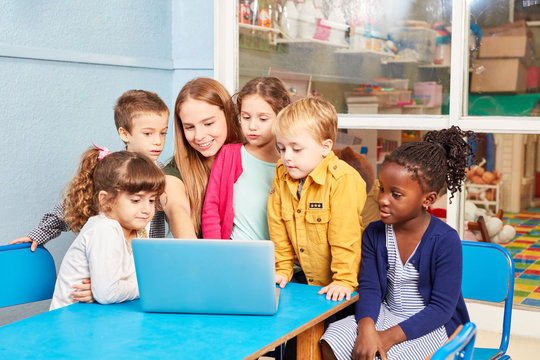 Teacher With Children On Laptop Computer