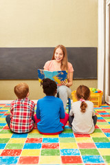 Kindergarten teacher reading aloud in kindergarten