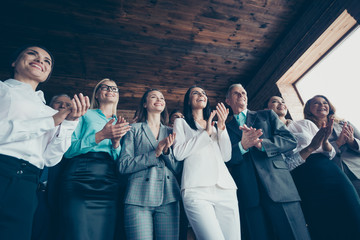 CLose up low angle view photo of people applausing in inspiration to boss who came in office with win after companies competition all dressed in formal wear jackets shirts