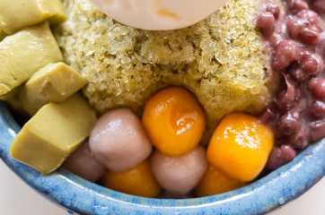 eating shaved ice with colorful dessert