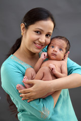 Cheerful mother holding baby boy - 276488320