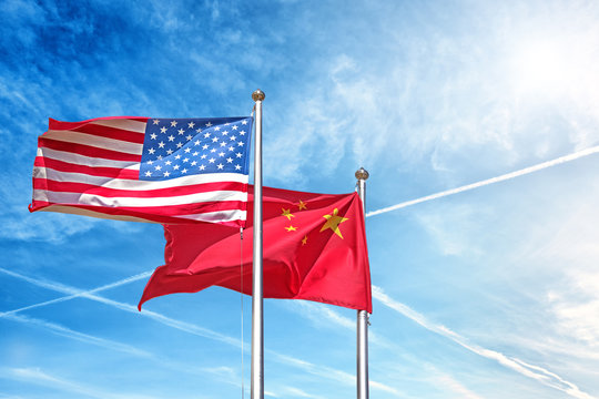 usa and china national flag waving against clouds blue sky side view of natural color of united states of america us and people republic of china state symbols isolated for design copy space template
