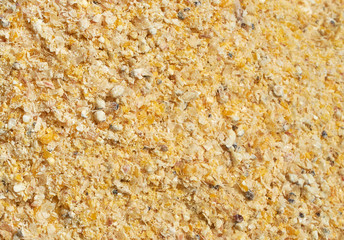 Background texture of crushed seed and grain mix for livestock and bird feed
