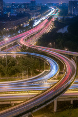 Fototapeta na wymiar Large interchange with busy traffic aerial view at night in Chengdu, China