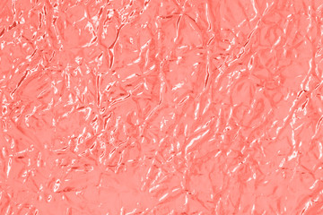 Holographic multicolored real crumpled texture background in blue and pink shades.