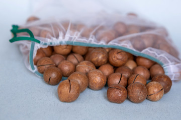 Nuts in eco-friendly packaging. Reusable bags for vegetables and fruits. Shopping in the store. Eco-friendly packaging. Caring for the Earth.