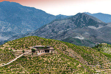 An alone house on the top of the mountain 