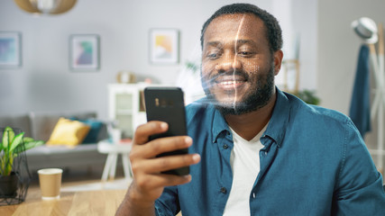 Young Man Identified by Biometric Facial Recognition Scanning Process from His Smartphone. Futuristic Concept: Projector Identifies Individual by Illuminating Face by Dots and Scanning with Laser