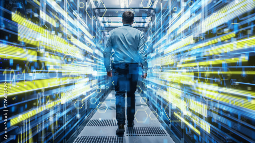 Poster Shot of a Young It Specialist Walking through Corridor in Working Data Center Full of Rack Servers and Supercomputers. Conceptual Visualisation of High Speed Internet Connection with Yellow Lines.