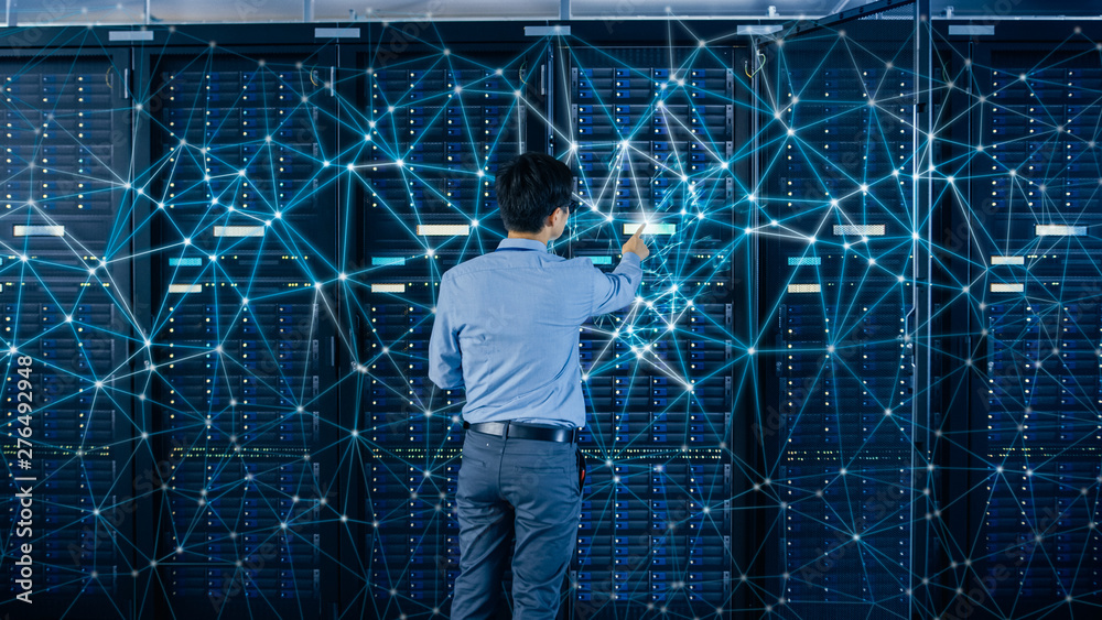 Aufkleber Internet Web Concept. Shot In the Modern Data Center: IT Engineer Standing Beside Open Server Rack Cabinets and Touching Digital Connections on a Server.