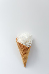 White peony flower in waffle horn on white background