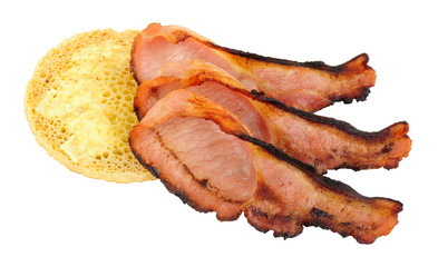Grilled bacon rashers and pikelet crumpet isolated on a white background