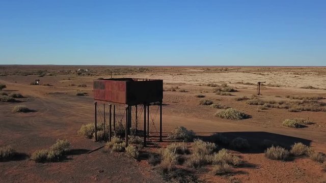 Drone shot flying around an old railway water tank used on the Ghan railway in the Australian outback.