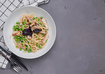 Green spring spaghetti with peas in white plate
