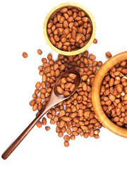 uncooked peanut bean in the wooden bowl and spoon isolated on white background, top view.