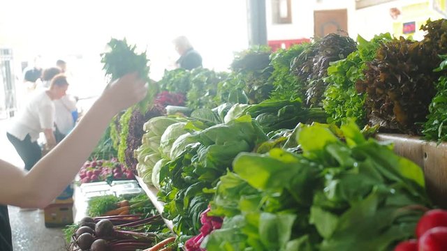 Fresh organic produce on sale at the small local farmers market. Selling organic vegetables and greenery at market. Agriculture industry concept. Organic farm food harvest