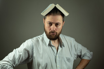 Casual business man with a book using education to overcome business challenges