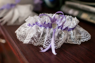 Blue with purple color garter lying on the wooden table