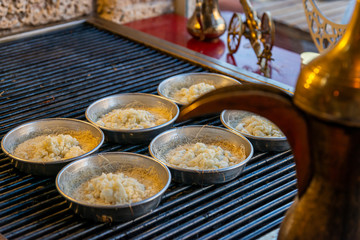 Preparing personal knafeh in a tray