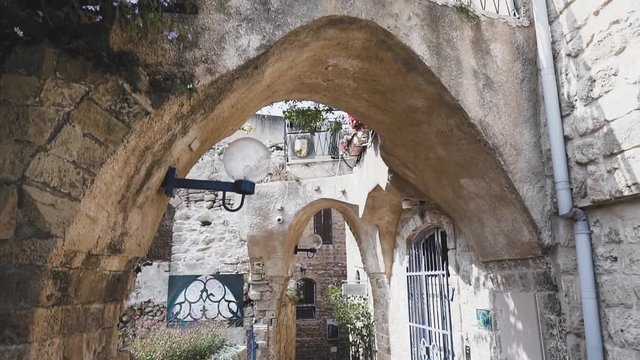 Architectural arches on street of Jaffa old city, Israel, crane shot.