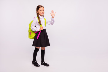 Full length body size view portrait of her she nice attractive lovely friendly cheerful cheery pre-teen girl waving hi hello isolated over light white grey background © deagreez