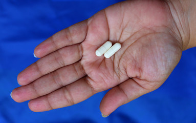 Chitosan capsules lying on a female hand
